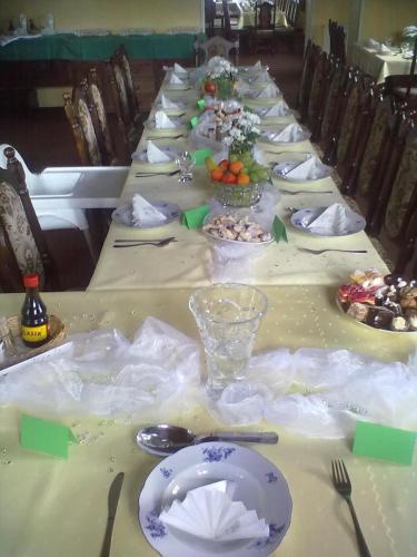 a long table with plates of food on it at Penzion na Čertovce in Dolní Orlice
