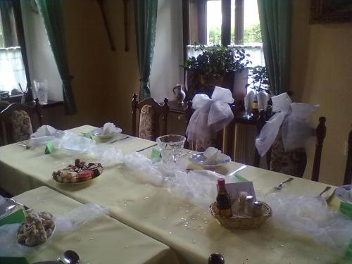 a table with a white table cloth on it at Penzion na Čertovce in Dolní Orlice