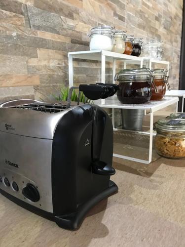 a toaster oven sitting on the floor next to a counter at B&B Villa degli Angeli in Bernalda