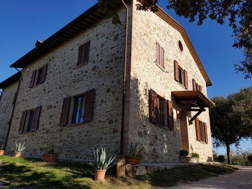 a large stone building with windows on the side of it at La Collina in Deruta