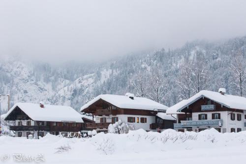 a group of buildings covered in snow at DEVA Hotel Kaiserblick in Reit im Winkl