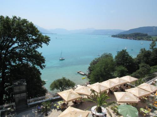 a view of a beach with a boat in the water at Hotel Attersee in Seewalchen