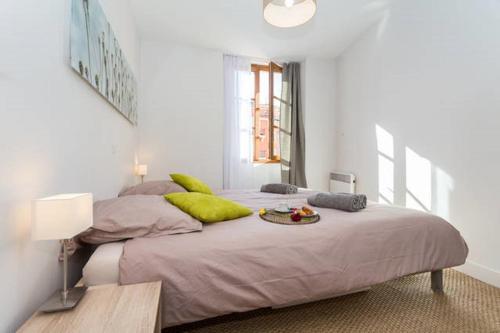 une chambre avec un grand lit avec des oreillers verts dans l'établissement LE ROSSETTI B. - modern, long balcony, old town Nice, à Nice