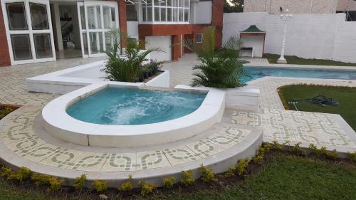 a hot tub in the middle of a yard at Hostal Mallorca Boutique in Cali