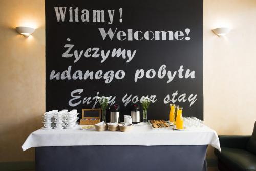 a table with a sign that says vitaminatown welcomeemeteryurancepol at Campanile Lublin in Lublin