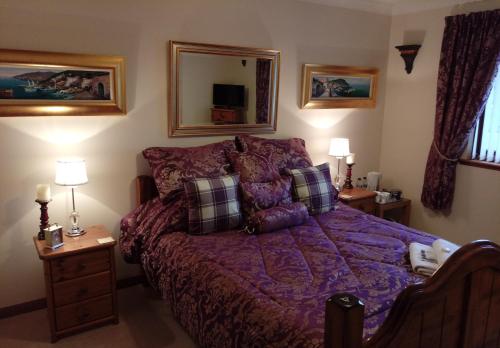 
a bedroom with a bed and a lamp at One Strathview B&B in Forfar

