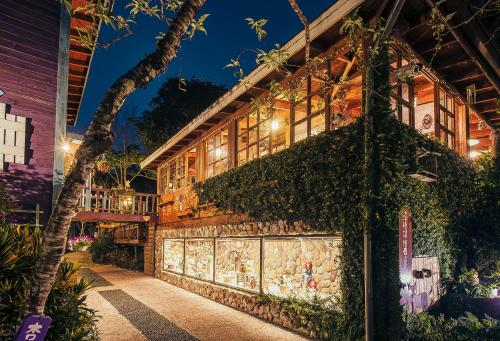 a building with ivy on the side of it at 南庄橄欖樹咖啡民宿 Olive Tree Village Guesthouse in Nanzhuang