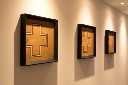 a wall with three different doors on a wall at Hotel Brunnenhaus Schloss Landau in Bad Arolsen