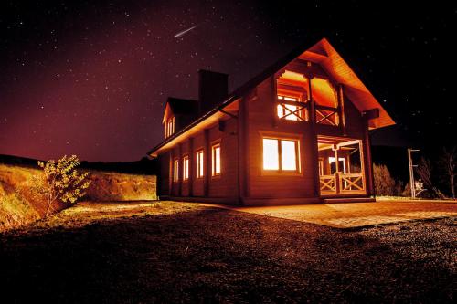 a house at night with the lights on at Sielska Chyża in Rzepedż