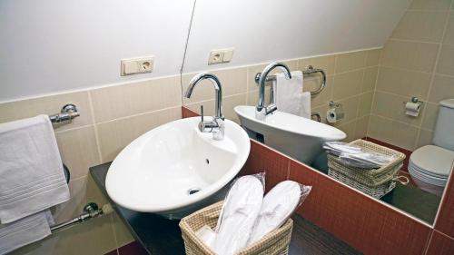 a bathroom with a sink and a toilet and a mirror at Villa Jurmala in Jūrmala