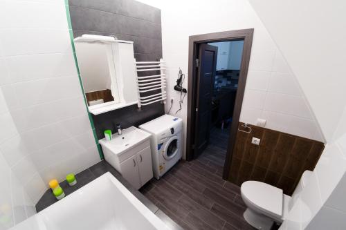 a bathroom with a white toilet and a sink at Furmanska 3 in Lviv