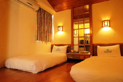 Ένα ή περισσότερα κρεβάτια σε δωμάτιο στο Traveler Hotel Taitung