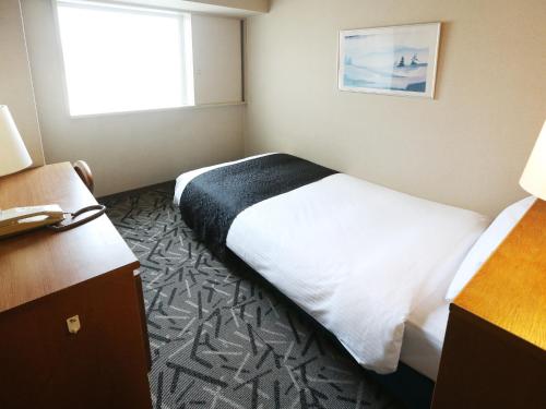 Postel nebo postele na pokoji v ubytování APA Hotel & Resort Sapporo