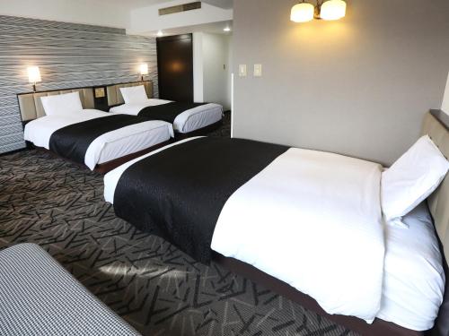 Postel nebo postele na pokoji v ubytování APA Hotel & Resort Sapporo