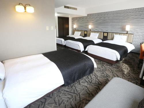 Postel nebo postele na pokoji v ubytování APA Hotel & Resort Sapporo