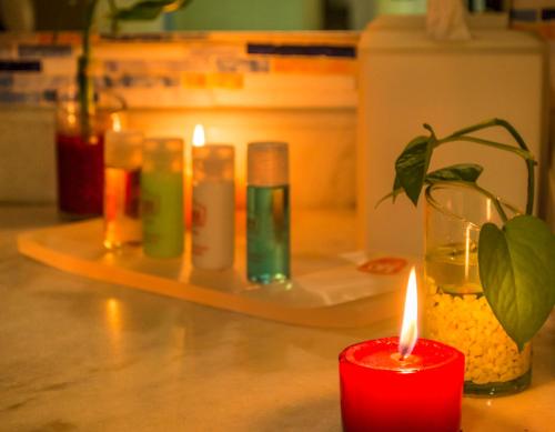 a group of candles sitting on a counter with a plant at GHL Relax Hotel Costa Azul in Santa Marta