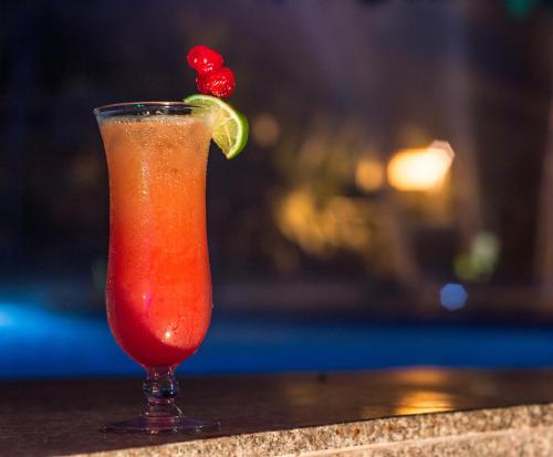a drink sitting on a table with a red drink at GHL Relax Hotel Costa Azul in Santa Marta