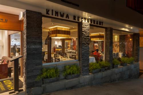 a store front of a restaurant with plants at Inti Punku Machupicchu Hotel & Suites in Machu Picchu