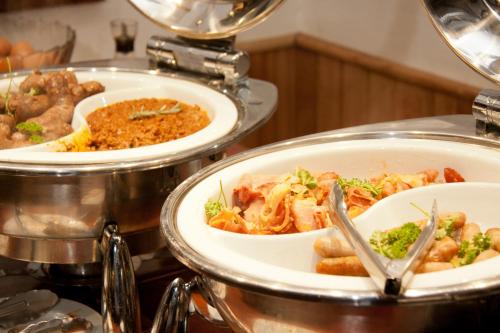 a buffet with three plates of food on a table at Tzaneen Country Lodge in Tzaneen
