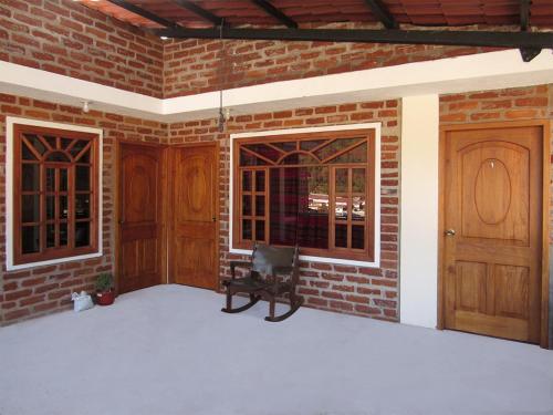 a room with two wooden doors and a brick wall at Hostal Viajero's in Baños