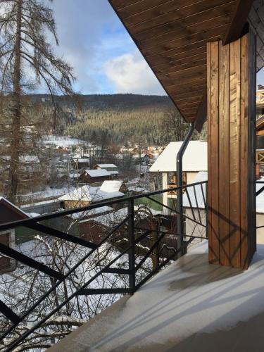 a view from the balcony of a house in the snow at Girske Povitria 2 in Yaremche