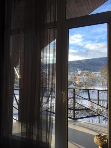 a room with a window with a view of a bridge at Girske Povitria 2 in Yaremche