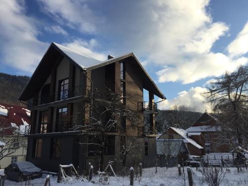 a house with snow on the ground at Girske Povitria 2 in Yaremche