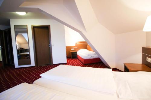 a hotel room with two beds and a staircase at Hotel-Gasthof Obermeier in Allershausen