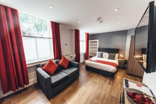 a living room with a bed and a couch at The Stay Company, Friar Gate in Derby