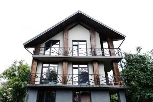 a house with a balcony on top of it at Girske Povitria 2 in Yaremche