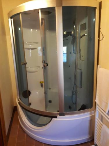 a shower with a glass door in a bathroom at Il Gelso Room&breakfast in Pennabilli