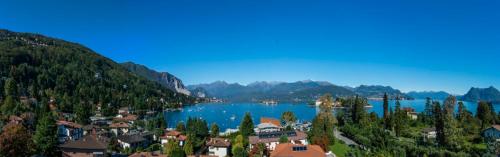 a town on a lake with mountains in the background at Hotel Royal in Stresa