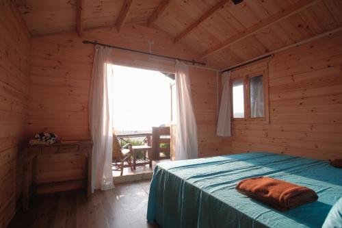 a bedroom with a bed in a log cabin at Agonda Paradise in Agonda