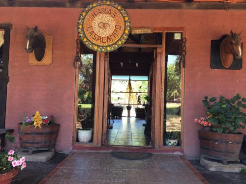 an entrance to a building with a horse on the wall at Hotel Haras Casacampo in Quintero