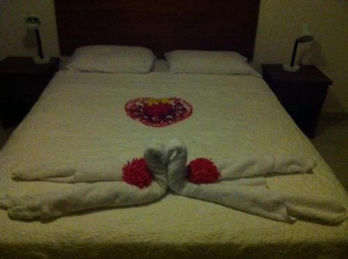 a bed with a heart made up on it at Casa Loma in Pedasí Town