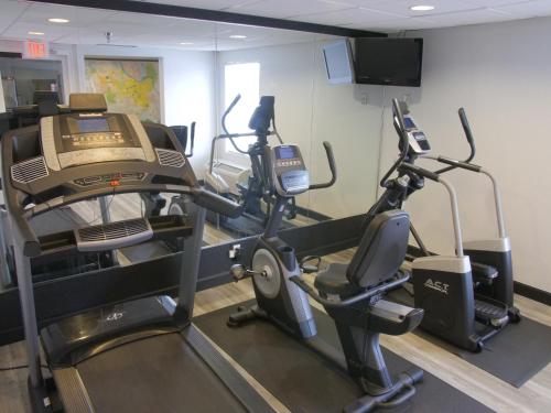 a gym with two ellipticals and two tread machines at Baymont by Wyndham Louisville East in Louisville