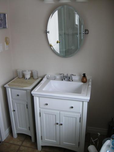 a bathroom with a sink and a mirror on the wall at Tucked Inn the Harbour B&B in Victoria Harbour
