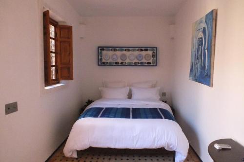 a small bedroom with a bed in the corner at Dar Faracha Fes in Fès