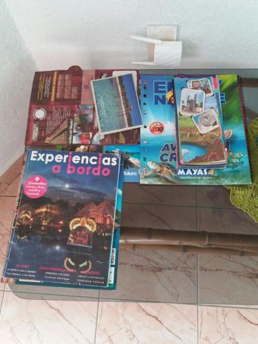 a pile of books sitting on top of a table at Room in Cancun Stadium in Cancún