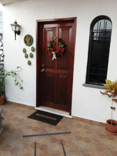 a door of a house with a wreath on it at Room in Cancun Stadium in Cancún
