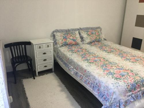a bedroom with a bed and a dresser and a chair at Jarmila Vendégház in Balatonberény