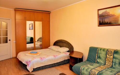 a small bedroom with a bed and a chair at Квартира по переулку Бутышева, 17 in Kyiv
