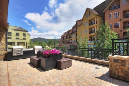 a balcony with some flowers and some buildings at Village at Breckenridge, A Vail Resorts Property in Breckenridge