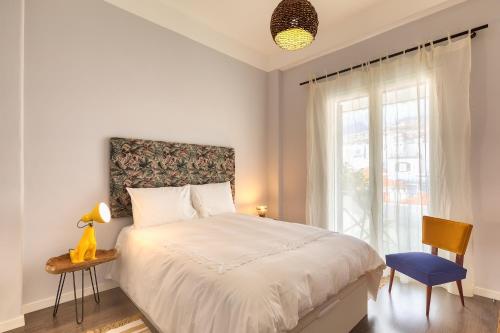 a bedroom with a large bed and a window at Endemic - Concept Apartment in Funchal