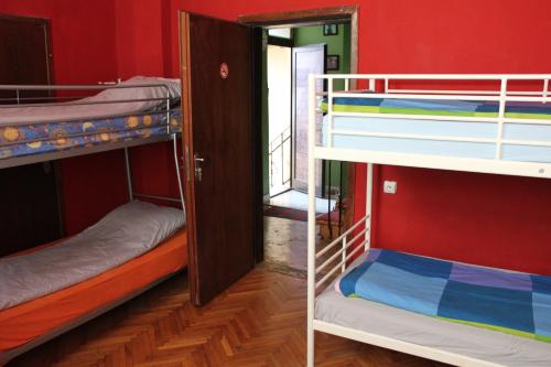 two bunk beds in a room with a door at Fun House in Bucharest