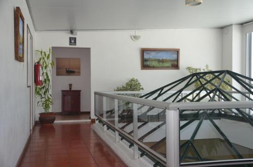 a hallway with a staircase in a house at Hotel Romi in Colonia del Sacramento