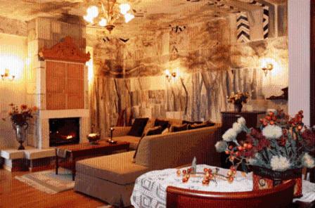 a living room with a couch and a fireplace at Leventis Art Suites in Panayítsa