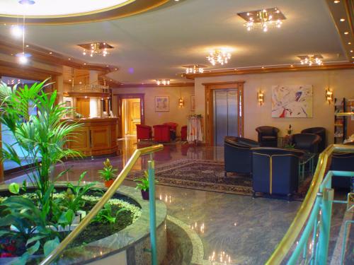 a lobby with a waiting room with plants in it at Hotel Marxzeller Mühle in Marxzell