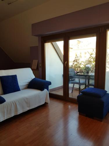 a living room with a bed and a sliding glass door at Aramis House Navigli - con parcheggio Gratis - with Free parking - zona Navigli -Bocconi- Porta Genova in Milan