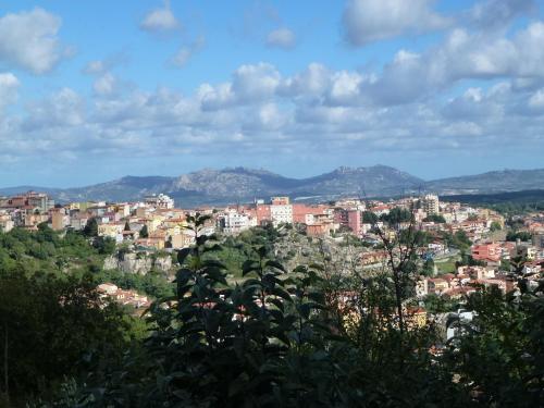 a view of a city with buildings and trees at B&B Meladormo in Tempio Pausania